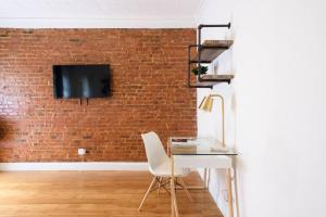 a room with a desk and a brick wall at 454-4R New 2BR prime midtown Best value Sleeps 5 in New York