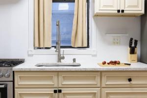 a kitchen counter with a sink and a window at 454-4R New 2BR prime midtown Best value Sleeps 5 in New York