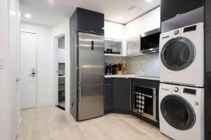 a kitchen with a refrigerator and a washer and dryer at 75-1A NEW Prime UES W D in unit Elevator in New York