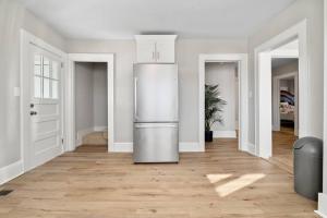a kitchen with a refrigerator in the middle of a room at Cozy 4B Retreat Near Uptown King Beds Sleeps 12 in Charlotte