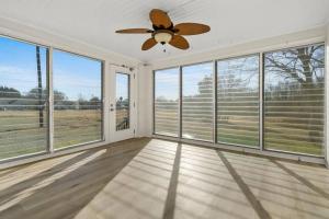 a large room with windows and a ceiling fan at Cozy 4B Retreat Near Uptown King Beds Sleeps 12 in Charlotte