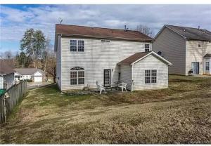 a large white house with a fence and a yard at Cozy 4B 2 5B University Home King Beds Jacuzzi in Charlotte