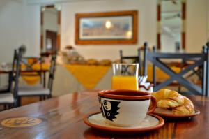 a cup of coffee and croissants and a glass of orange juice at Hotel Asturias in Cafayate