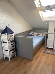 a dorm room with a bed in a room at Spacious loft converted bedroom with toilet only, Separate guest shower on ground floor plus free parking in Hanworth