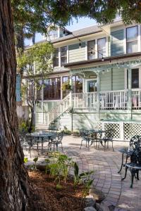 a group of tables and benches in front of a building at Centrella Hotel, a Kirkwood Collection Hotel in Pacific Grove