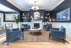 a living room with blue walls and a fireplace at Prentiss House by Thatch in Cambridge