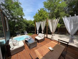 - Terraza con piscina, sillas y mesa en Superbe Cabane JACUZZI JARDIN CLIM WIFI PARKING, en Meyreuil