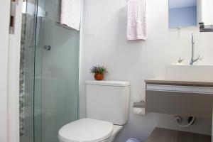 a bathroom with a toilet and a sink and a shower at Solar da Lorena in Florianópolis