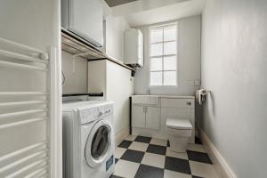 a white laundry room with a washer and dryer at Chadbury House Annexe in Evesham