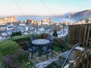 a table and chairs on a patio with a view at Potters Cottage in Lynton