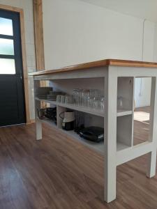 a white table with glasses on a shelf at Casa Bulnes in Constitución