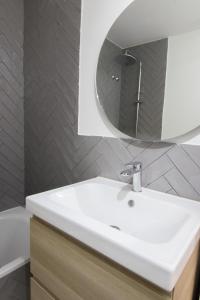 a bathroom with a white sink and a mirror at BAMBOO IV - tucasaenlospirineos in Escarrilla