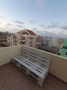 a bench sitting on the ledge of a balcony at Tres Caravelas Studio Flats in Santa Maria