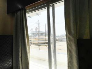 a window with curtains in a room with a view at ojotrip Hotel Basanti INN- puri in Puri