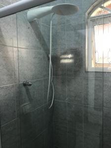 a shower with a shower head in a bathroom at Pousada da Benção in Cachoeira Paulista