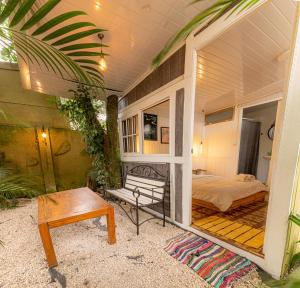 a room with a bed and a table and a bench at Finca Escalante in San José