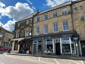 a building on a city street with a store at Angel Lane Alnwick Apartment in Alnwick