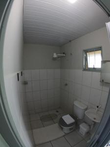 a bathroom with a toilet and a sink at Pousada Solar da Montanha in Pedreira +85 photos