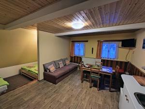 a living room with a couch and a table at Penzion Pod můstky in Harrachov