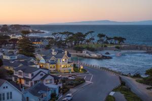 a group of houses in front of the ocean at Seven Gables Inn on Monterey Bay, A Kirkwood Collection Hotel in Pacific Grove