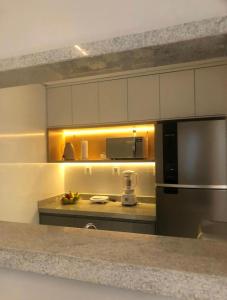 a kitchen with a stainless steel refrigerator and a counter at Diamond é o seu lugar ! in Belo Horizonte