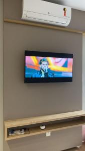 a flat screen tv hanging on a wall at Diamond é o seu lugar ! in Belo Horizonte