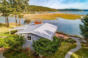 an aerial view of a house on the shore of a lake at Oasis By The Sea in Port Hadlock