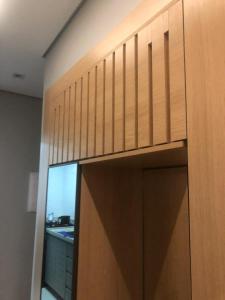 a wooden door in a room with a window at Diamond é o seu lugar ! in Belo Horizonte