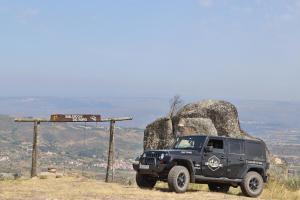 a black jeep parked on top of a hill at Encosta do Sobreiro - Serra da Estrela in Fornos de Algodres +49 photos