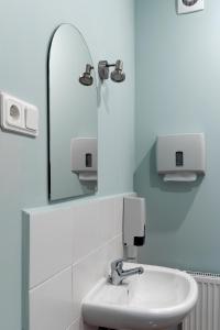 a bathroom with a sink and a mirror at Juku Dzirnavas in Zutēni +56 photos