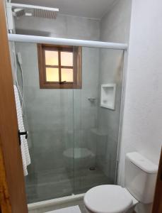 baño con ducha, aseo y ventana en Pouso Araris - Araras, Vale das Videiras, en Petrópolis
