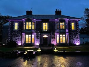 a house with purple lights on the front of it at The Lloyd George in Caernarfon