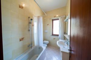 a bathroom with a tub and a sink and a toilet at Il Rifugio Del Merlo in Amalfi