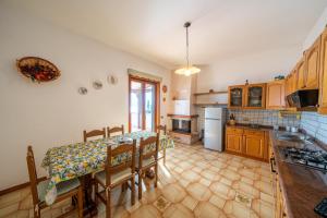 a kitchen with a table and a dining room at Il Rifugio Del Merlo in Amalfi +14 photos