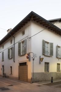 un bâtiment blanc avec des volets verts et un garage dans l'établissement Grazioso appartamento in centro storico Chiari, à Chiari