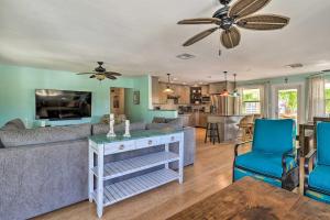 a living room with a couch and a table at Key Largo Paradise with Heated Pool and Hot Tub! in Key Largo
