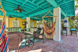 een patio met stoelen en hangmatten op een huis bij Key Largo Paradise with Heated Pool and Hot Tub! in Key Largo
