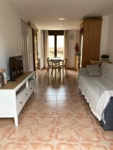 a bedroom with a bed and a tv and a table at Casa ELENA i MARTA , Valdelinares in Valdelinares