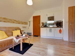 a living room with a couch and a table and a kitchen at Villa Apia in Piwniczna-Zdrój