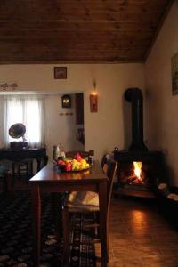 a living room with a table and a fireplace at Chateaux Constantin Agistro in Ángistron