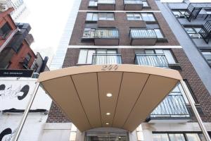 a building with awning in front of a building at 75-2D NEW Prime UES W&D Balcony Elevator in New York