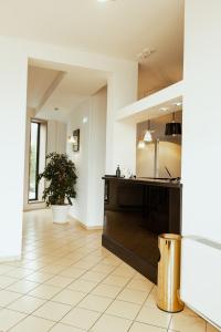 a large kitchen with a counter and a table at Tuo Hotel in Polignano a Mare