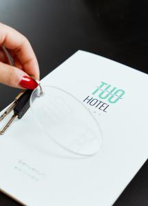 a person cutting a piece of paper with scissors at Tuo Hotel in Polignano a Mare