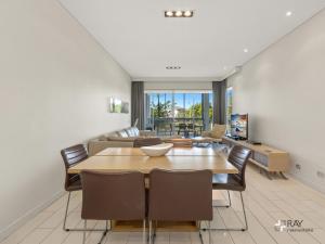 a dining room with a table and chairs at Bale Luxury Resort - Holiday Management in Kingscliff