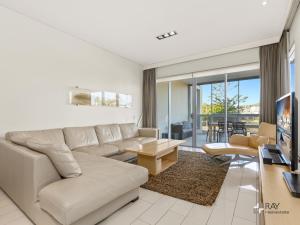 a living room with a couch and a table at Bale Luxury Resort - Holiday Management in Kingscliff