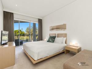 a bedroom with a large white bed and a window at Bali Luxury Resort - Holiday Management in Kingscliff +105 photos