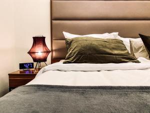 een bed met een groen kussen en een nachtkastje met een lamp bij Charming Apartment, Wawel & Old Town Krakow II in Krakau