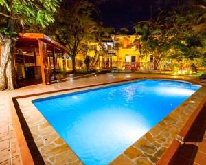 a large blue swimming pool at night at Dafina Residence in Dar es Salaam