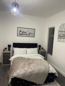 a bedroom with a bed and two night stands at Short Stopzzz & Indoor Hot Tub in Manchester