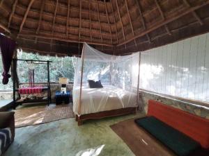 a bedroom with a canopy bed in a room at Toto Aiko in Tulum